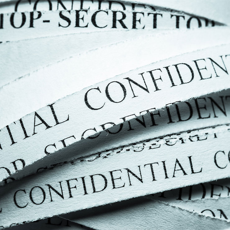 Shredded documents with confidential written on them